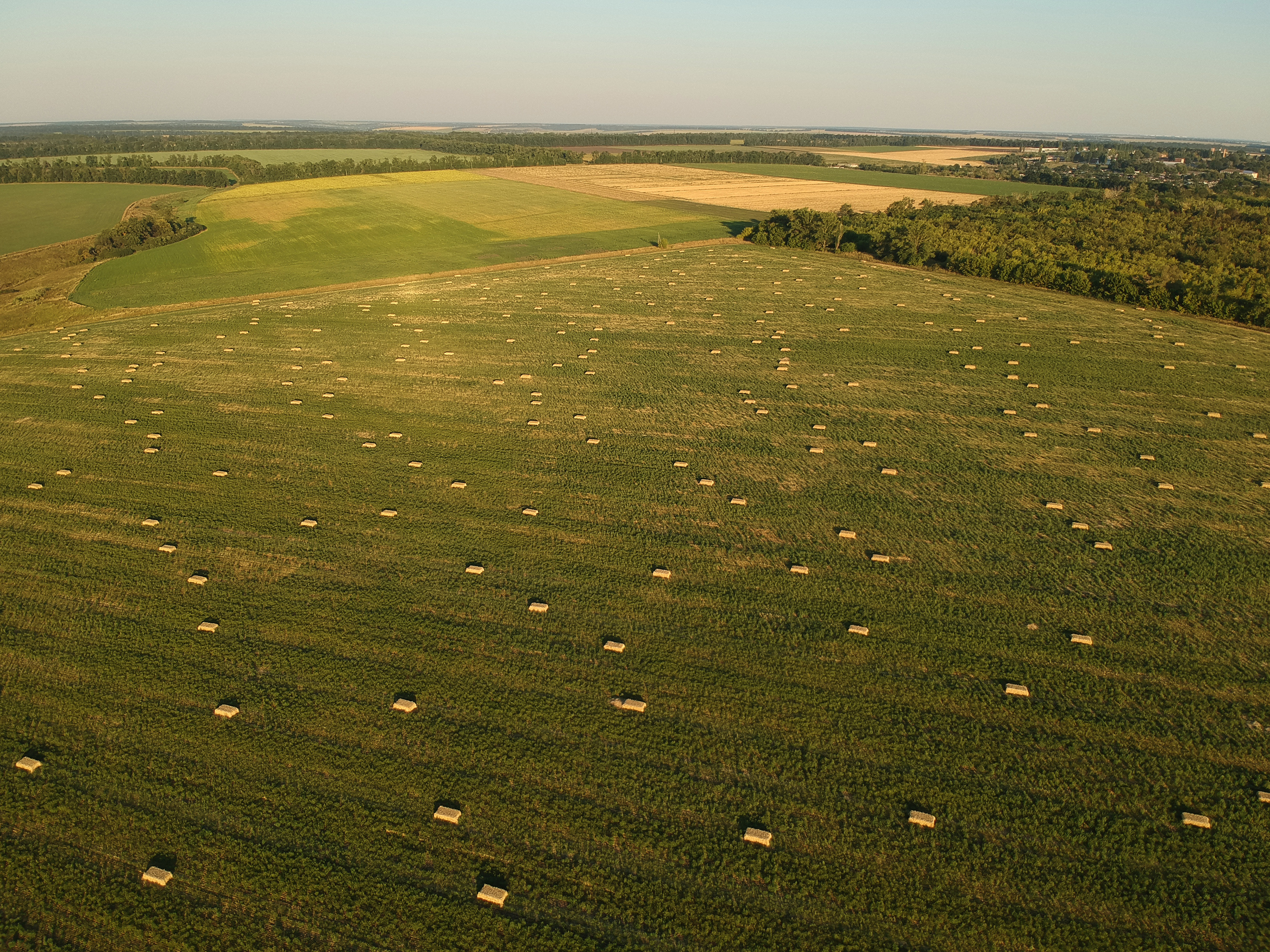 aerial-view-to-stacked-hay-on-the-wheat-field-unde-2022-01-29-09-04-54-utc.JPG